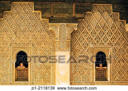 Stock Photo - two girls looking from decorated windows at the Bahia Palace in Marrakech, Maroc. Fotosearch