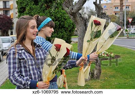 Two girls offering roses on the street at the feast of St George, Dos chicas ofreciendo rosas en la calle en la fiesta de Sant Jordi View Large Photo Image Stock Photography - Two girls offering roses on the street at the feast of St George, Dos chicas ofreciendo rosas en la calle en la fiesta de Sant Jordi. Fotosearch