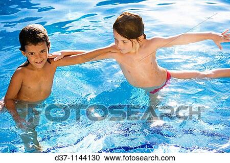 Two girls playing in a swimming pool View Large Photo Image Stock Image - Two girls playing in a swimming pool. Fotosearch