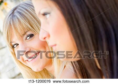 Two girls portraits, selective focus View Large Photo Image Stock Photograph - Two girls portraits, selective focus. Fotosearch