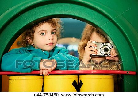 Two girls taking photos with a digital camera View Large Photo Image Stock Image - Two girls taking photos with a digital camera. Fotosearch