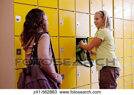 Two girls talking in the hallway. View Large Photo Image Stock Image - Two girls talking in the hallway.. Fotosearch