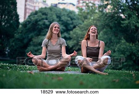 Two girls trying to do yoga View Large Photo Image Stock Photo - Two girls trying to do yoga. Fotosearch