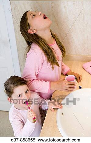 Stock Photography - Two girls washing the teeth. Fotosearch