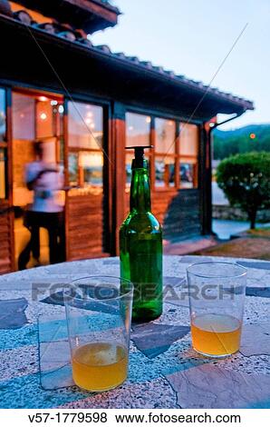 Stock Photo - Two glasses of cider at evening. Asturias, Spain.. Fotosearch