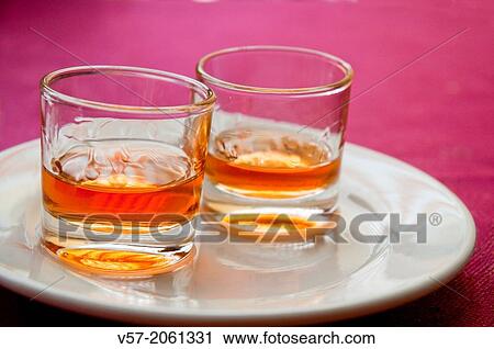 Two glasses of liqueur. Close view. View Large Photo Image Stock Image - Two glasses of liqueur. Close view.. Fotosearch