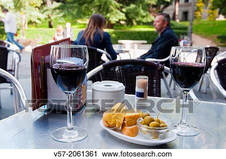 Two glasses of red wine with typical tapa in a terrace. Madrid, Spain. View Large Photo Image Stock Image - Two glasses of red wine with typical tapa in a terrace. Madrid, Spain.. Fotosearch