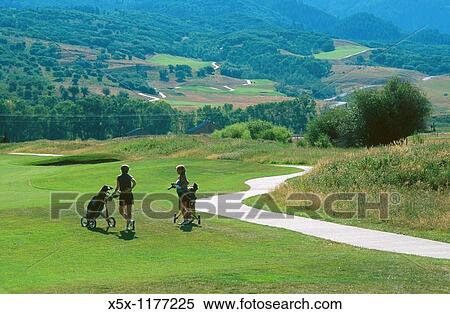 Stock Photography - Two golfers on the fairway of Haymaker golf course in Steamboat Springs, Colorado, USA. Fotosearch