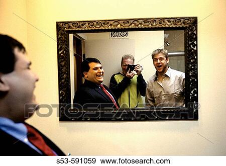 Two guys and a photographer looking into a mirror. View Large Photo Image Stock Photo - Two guys and a photographer looking into a mirror.. Fotosearch