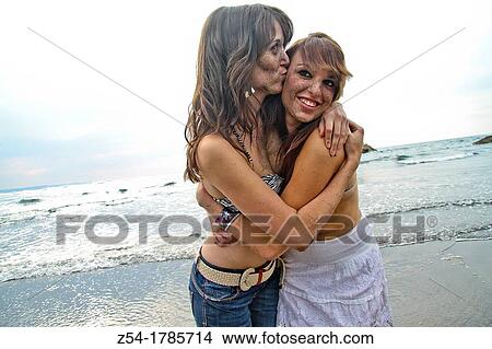 Picture - Two happy young women at El Sabl? n beach, Asturias, Spain. Fotosearch