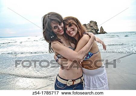 Two happy young women at El Sabl? n beach, Asturias, Spain View Large Photo Image Stock Photo - Two happy young women at El Sabl? n beach, Asturias, Spain. Fotosearch