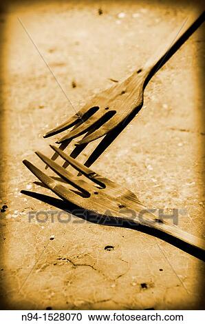 Stock Image - Two holders of wood drying in the sun in the kitchen window.. Fotosearch