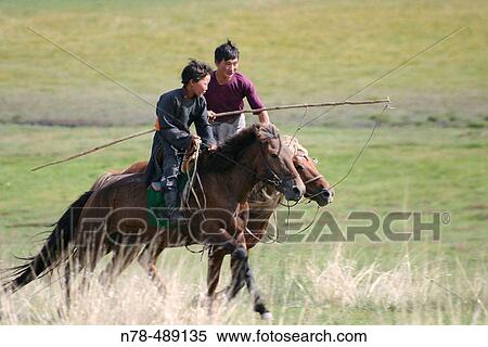 Two horsemen riding horses on steppe. Mongolia View Large Photo Image Stock Photography - Two horsemen riding horses on steppe. Mongolia. Fotosearch