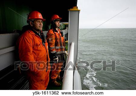 Stock Image - Two indonesian Seamen or sailors on the container-vessel MV Flintercape, during a journey from Rotterdam, Netherlands, to Sundsvall, Sweden.. Fotosearch