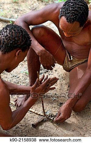 Two Jo/? hoansi San man making fire the traditional way, Namibia, Africa. View Large Photo Image Stock Photo - Two Jo/? hoansi San man making fire the traditional way, Namibia, Africa.. Fotosearch