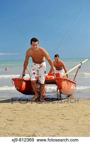 Two lifeguards move the boat rescue. View Large Photo Image Stock Photo - Two lifeguards move the boat rescue.. Fotosearch