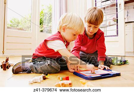 Two little boys playing together View Large Photo Image Picture - Two little boys playing together. Fotosearch