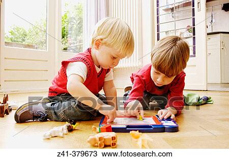 Two little boys playing together View Large Photo Image Stock Image - Two little boys playing together. Fotosearch