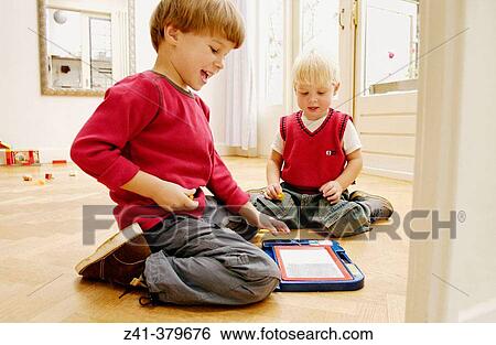 Stock Photograph - Two little boys playing together. Fotosearch
