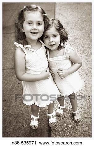 Stock Image - Two little girls embracing. Fotosearch