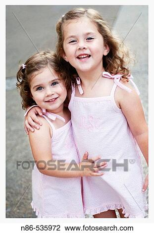 Two little girls embracing View Large Photo Image Stock Image - Two little girls embracing. Fotosearch