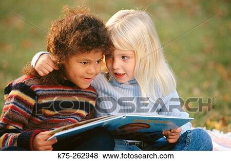 Two little girls reading View Large Photo Image Stock Photo - Two little girls reading. Fotosearch