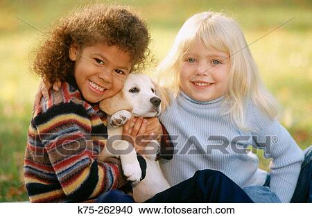 Two little girls with a puppy View Large Photo Image Stock Image - Two little girls with a puppy. Fotosearch