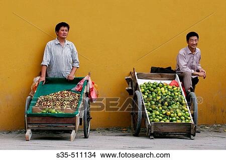 Two local fruit sellers in Suzhou, Jiangsu Province, China View Large Photo Image Picture - Two local fruit sellers in Suzhou, Jiangsu Province, China. Fotosearch