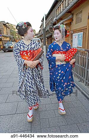 Two? Maiko? (geisha apprentices) walking to their evening appointment in the traditional quarter of Gion. Kyoto. Kansai, Japan (Model Release) View Large Photo Image Picture - Two? Maiko? (geisha apprentices) walking to their evening appointment in the traditional quarter of Gion. Kyoto. Kansai, Japan (Model Release). Fotosearch