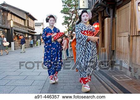 Two? Maiko? (geisha apprentices) walking to their evening appointment in the traditional quarter of Gion. Kyoto. Kansai, Japan (Model Release) View Large Photo Image Stock Photo - Two? Maiko? (geisha apprentices) walking to their evening appointment in the traditional quarter of Gion. Kyoto. Kansai, Japan (Model Release). Fotosearch