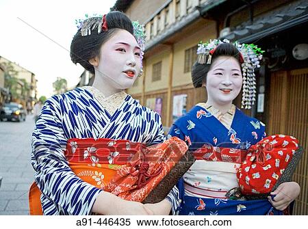 Two? Maiko? (geisha apprentices) walking to their evening appointment in the traditional quarter of Gion. Kyoto. Kansai, Japan (Model Release) View Large Photo Image Stock Photography - Two? Maiko? (geisha apprentices) walking to their evening appointment in the traditional quarter of Gion. Kyoto. Kansai, Japan (Model Release). Fotosearch
