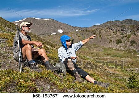 Stock Image - two male hikers in the Cayoosh Range of the Coast Mountains, British Columbia, Canada, near Downton Creek. Fotosearch