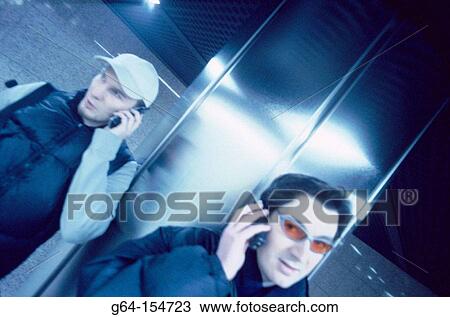 Two man talking on cell phones View Large Photo Image Stock Image - Two man talking on cell phones. Fotosearch