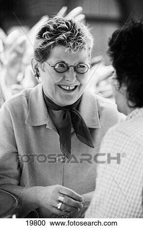 Two mature women talking View Large Photo Image Stock Image - Two mature women talking. Fotosearch