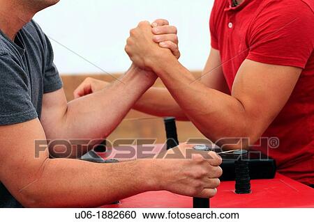 Two men competing in an arm wrestling competition View Large Photo Image Stock Image - Two men competing in an arm wrestling competition. Fotosearch
