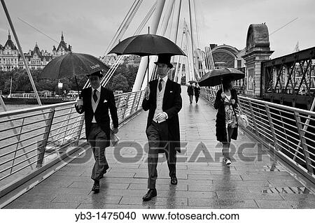 Two men dressed in suits cross Hungerford/Golden jubilee bridge on their way to Royal Ascot, London, England View Large Photo Image Stock Image - Two men dressed in suits cross Hungerford/Golden jubilee bridge on their way to Royal Ascot, London, England. Fotosearch