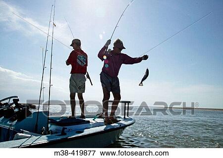 Two men fishing off a boat in Islamorada, Florida. December 2004. View Large Photo Image Stock Photo - Two men fishing off a boat in Islamorada, Florida. December 2004.. Fotosearch
