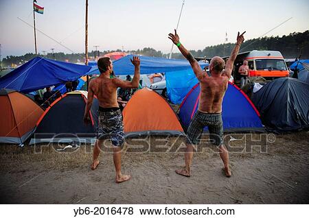 Two men having fun and cheering at the main campsite during the Przystanek Woodstock Music festival in Kostrzyn, Poland. View Large Photo Image Stock Photo - Two men having fun and cheering at the main campsite during the Przystanek Woodstock Music festival in Kostrzyn, Poland.. Fotosearch