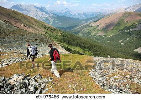 Stock Photograph - Two men hiking along ridge in Banff National Park, Canada. Fotosearch