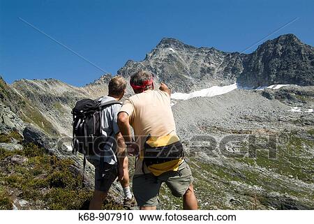 two men hiking in the Rocky Mountains above Rogers Pass, Glacier National Park, BC, Canada View Large Photo Image Stock Image - two men hiking in the Rocky Mountains above Rogers Pass, Glacier National Park, BC, Canada. Fotosearch
