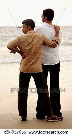 Two men looking out to sea on Kovalam beach, Kerala, India View Large Photo Image Stock Photography - Two men looking out to sea on Kovalam beach, Kerala, India. Fotosearch