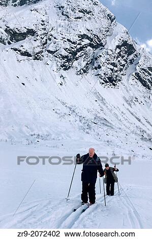 Two men nordic skiing in mountainous glacial valley, Jostedalsbreen, Norway. View Large Photo Image Stock Image - Two men nordic skiing in mountainous glacial valley, Jostedalsbreen, Norway.. Fotosearch