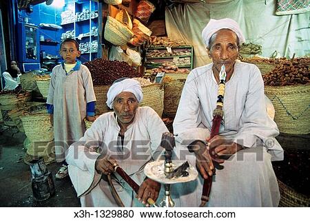 two men smoking hookah in front of their shop, Aswan, Egypt, Africa View Large Photo Image Stock Image - two men smoking hookah in front of their shop, Aswan, Egypt, Africa. Fotosearch