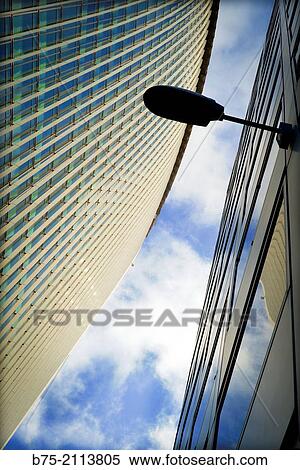 Two office buildings seen from the street with clouds in the sky and a lamppost in the City of London, England, UK, Europe. View Large Photo Image Stock Photography - Two office buildings seen from the street with clouds in the sky and a lamppost in the City of London, England, UK, Europe.. Fotosearch