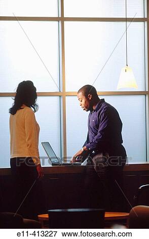 Two office workers talking View Large Photo Image Stock Photo - Two office workers talking. Fotosearch