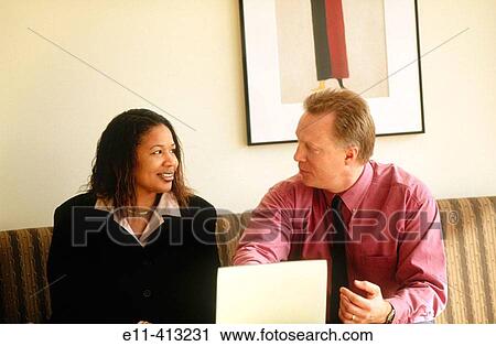 Two office workers with laptop View Large Photo Image Stock Image - Two office workers with laptop. Fotosearch