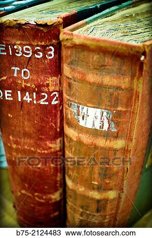Stock Image - two old books on a shelf. Fotosearch