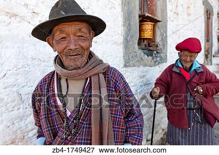 Two old men circling Jampa Lhakhang Temple, Jakar, Bumthang, Bhutan, Asia. View Large Photo Image Stock Photo - Two old men circling Jampa Lhakhang Temple, Jakar, Bumthang, Bhutan, Asia.. Fotosearch