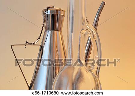 two olive oil bottles: one glass with long neck, one stainless steel View Large Photo Image Stock Image - two olive oil bottles: one glass with long neck, one stainless steel. Fotosearch