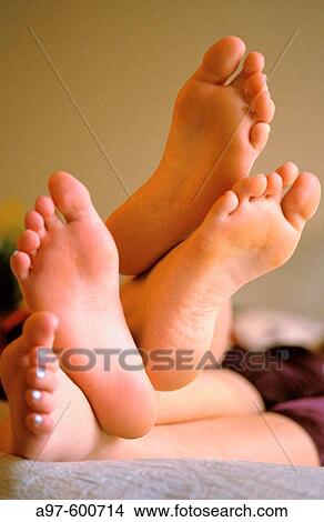 Two pairs of feet View Large Photo Image Picture - Two pairs of feet. Fotosearch